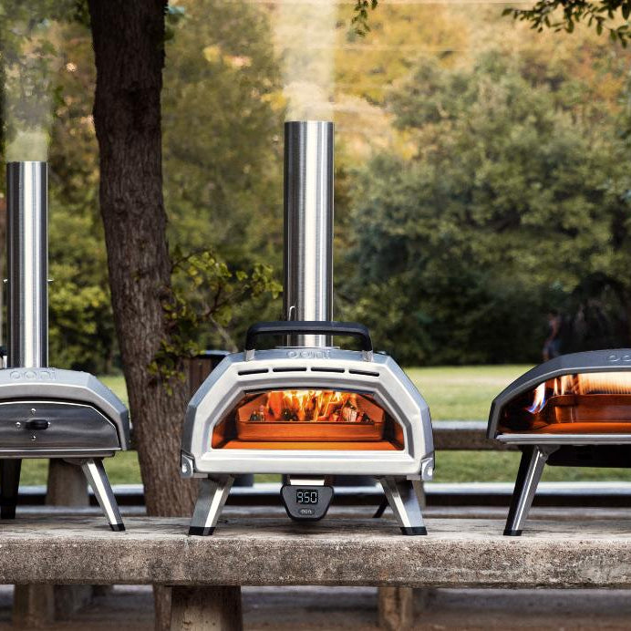 Collection of Ooni Pizza ovens on top of a wooden bench