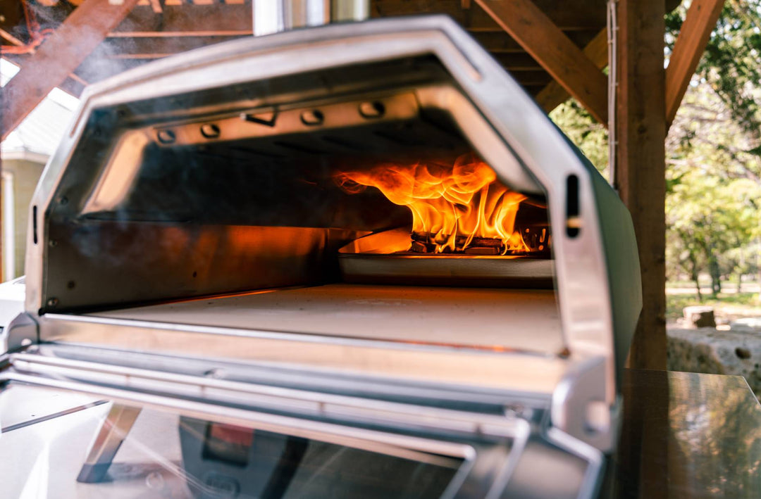 An Ooni Karu 16 pizza oven with its glass door open