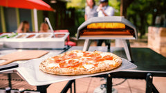 Koda 12 gas powered pizza oven and pizza on peel