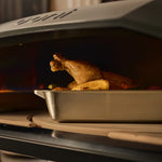 ooni roasting pan with chicken on rotating stone 