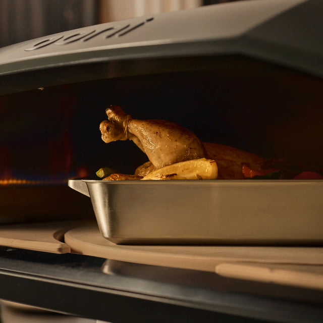 ooni roasting pan with chicken on rotating stone 