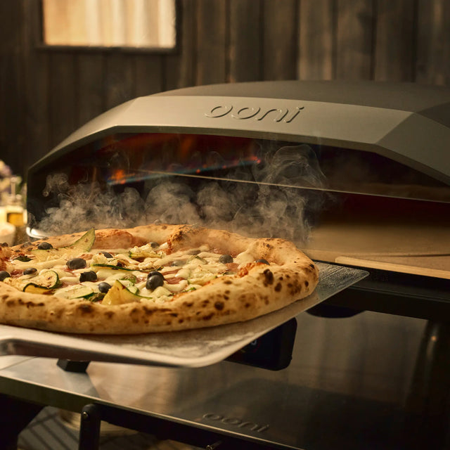 Koda 2 max rotating stone with pizza being retrieved from oven. 