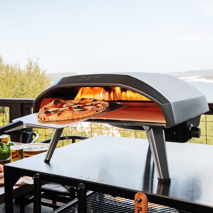 Koda 16 Pizza Oven with Pizza Peel on top of Modular Table | Click this image to open up the product gallery modal. The product gallery modal allows the images to be zoomed in on.