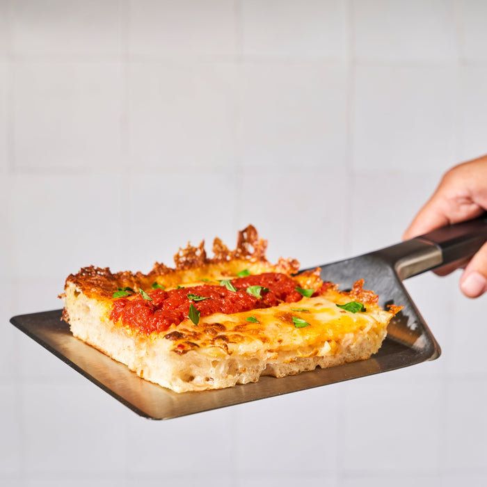 Ooni Pan Pizza Spatula with Detroit style Pizza | Click this image to open up the product gallery modal. The product gallery modal allows the images to be zoomed in on.