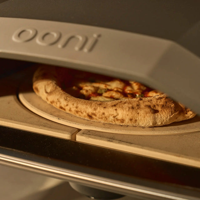 rotating stone with pizza cooking on it in Koda 2 