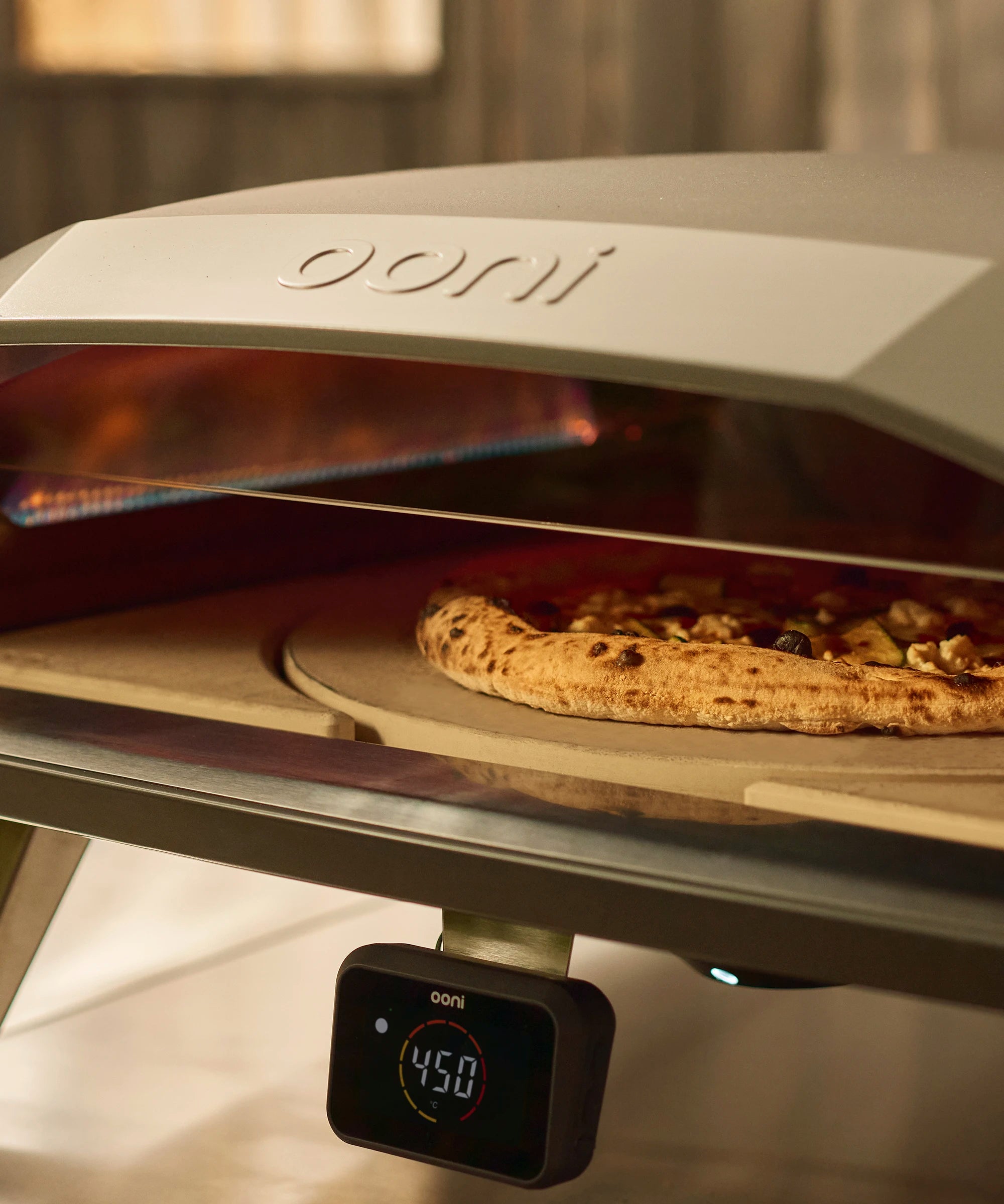 Pizza being cooked on the rotating stone in koda 