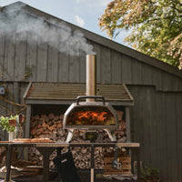 Ooni Karu 2 Pro Pizza Oven in an outdoors setting with cooked pizza