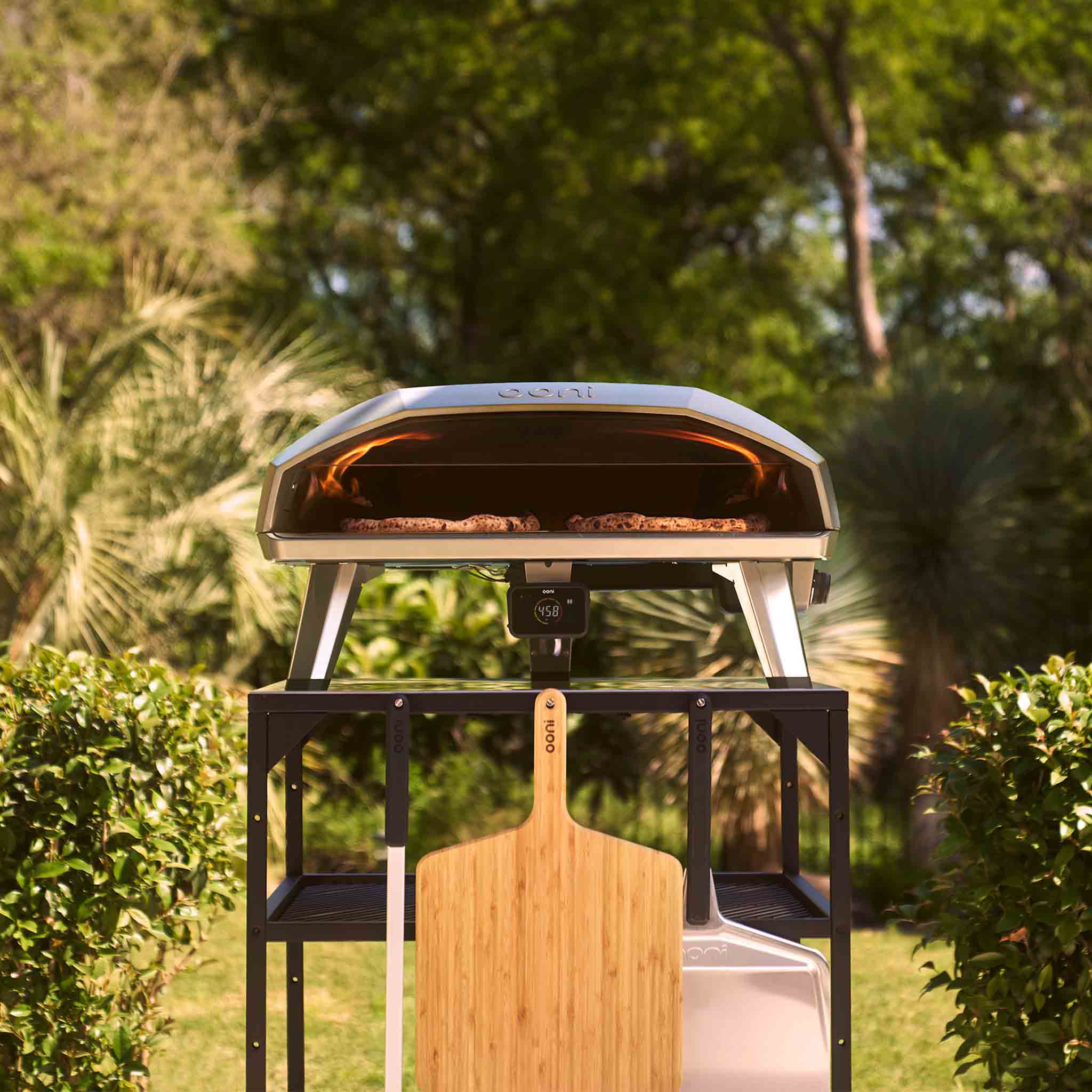 Koda 2 Max gas powered pizza oven on a large modular table in an outdoor setting. 